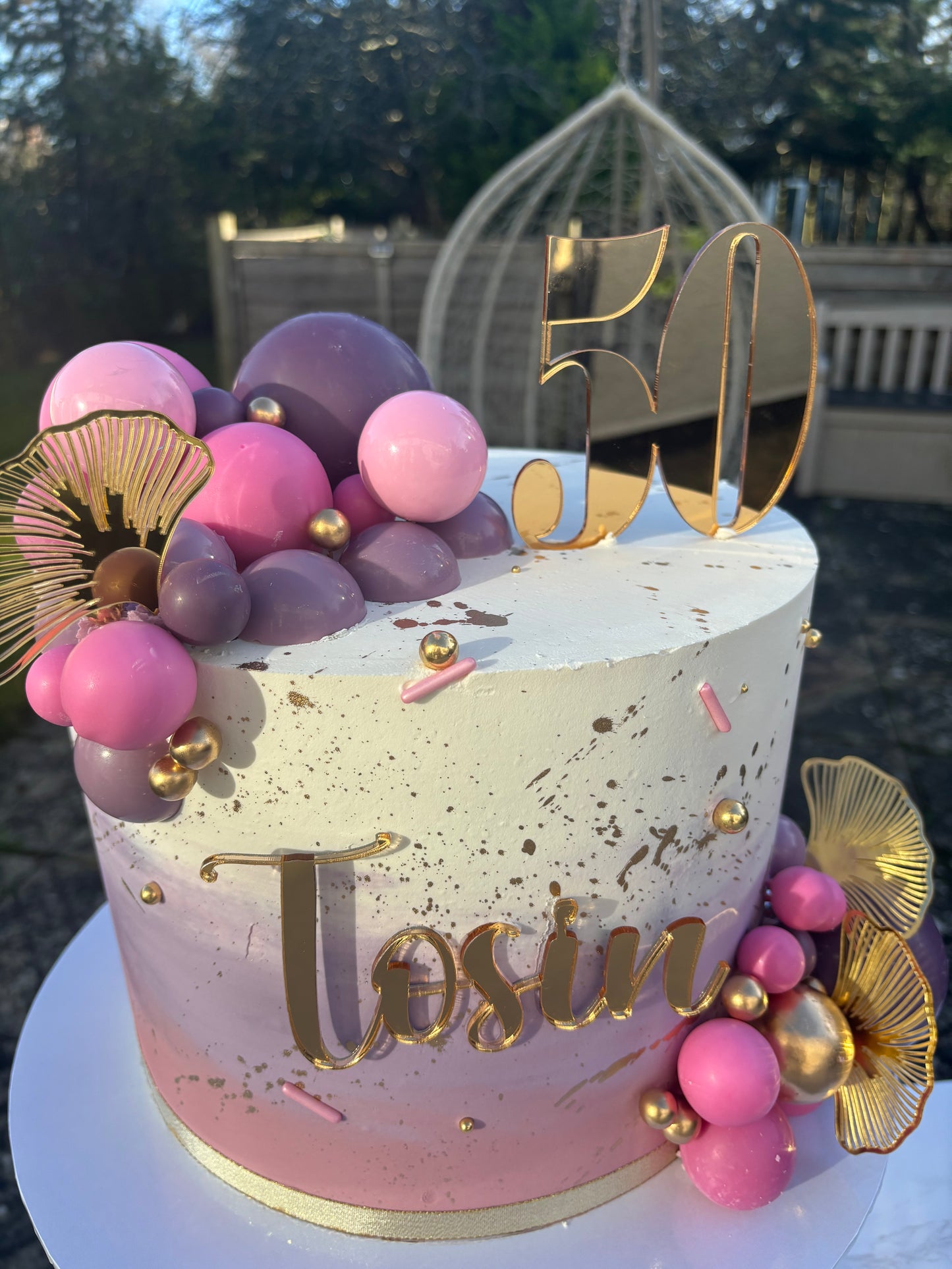 Pink and purple ombre with decorative balls.