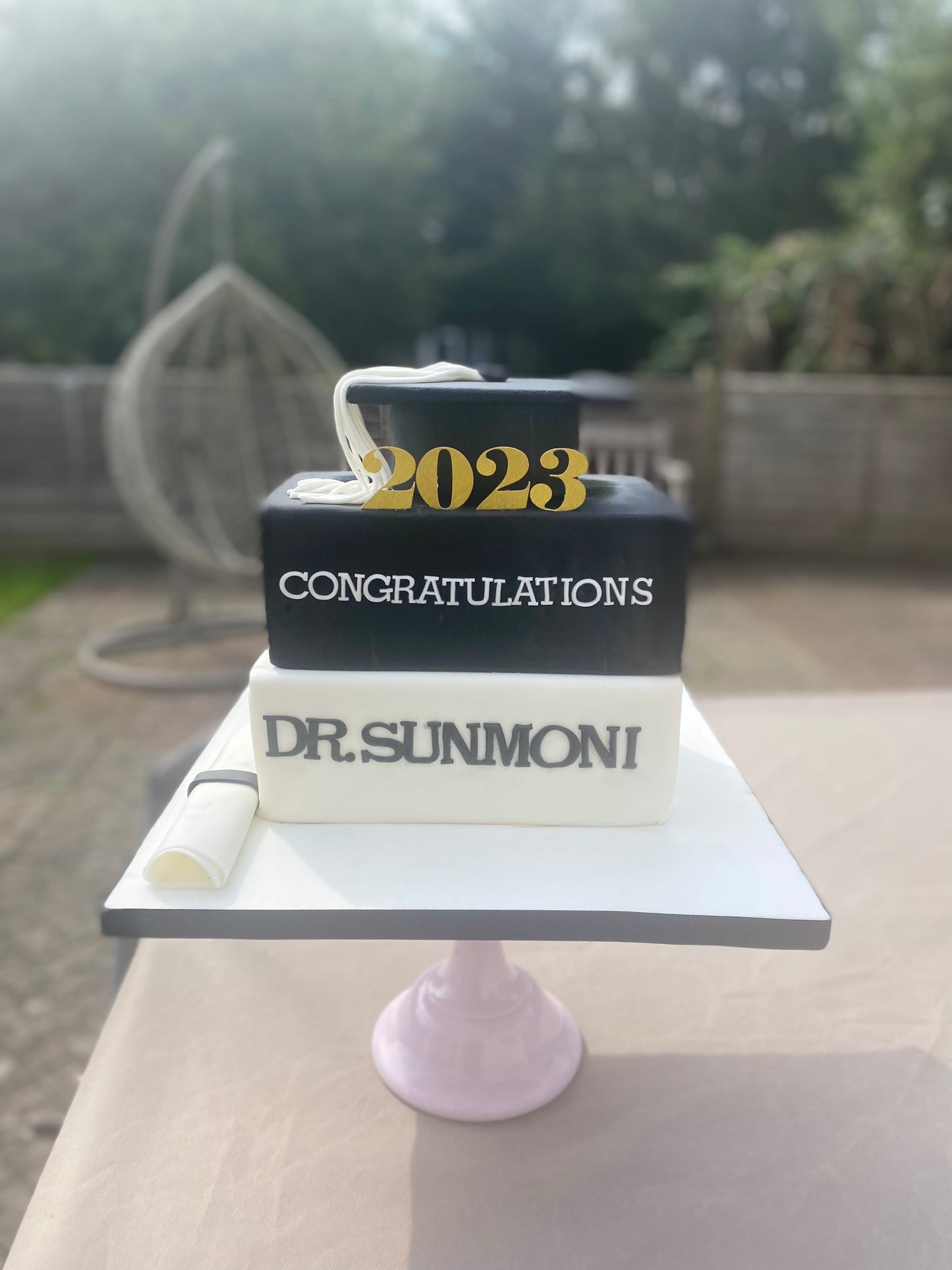 Graduation books and cap cake